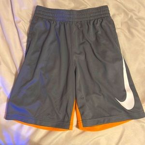 Nike dri-fit shorts, size medium, grey and orange color wave.